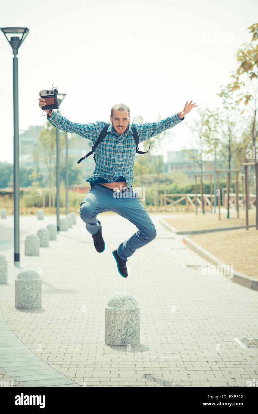 Modern Multitasking Man handsome hipster casual multitasking modern man with vintage camera in ...