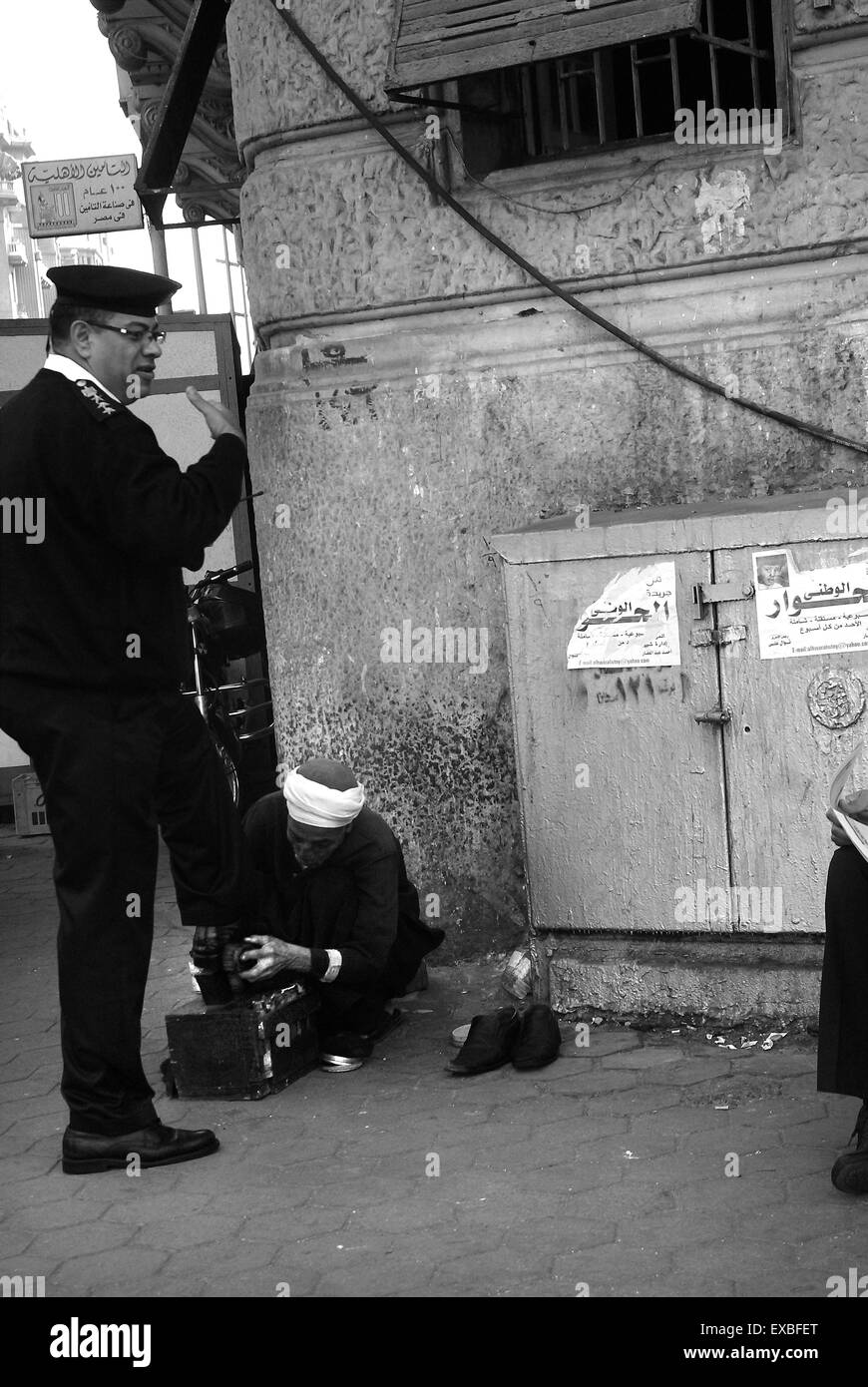 Policeman getting his shoes cleaned, Cairo, Egypt Stock Photo