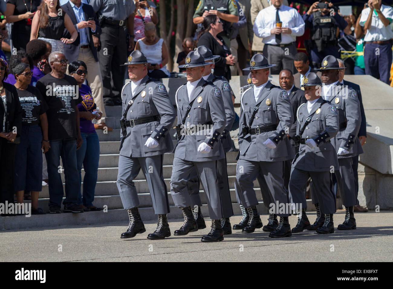 Columbia, South Carolina, USA. 10th July, 2015. South Carolina State police honor guard march past the families of those killed in the Charleston Nine massacre  as they begin the process to remove the Confederate flag the State House during a ceremony July 10, 2015 in Columbia, South Carolina. Credit:  Planetpix/Alamy Live News Stock Photo
