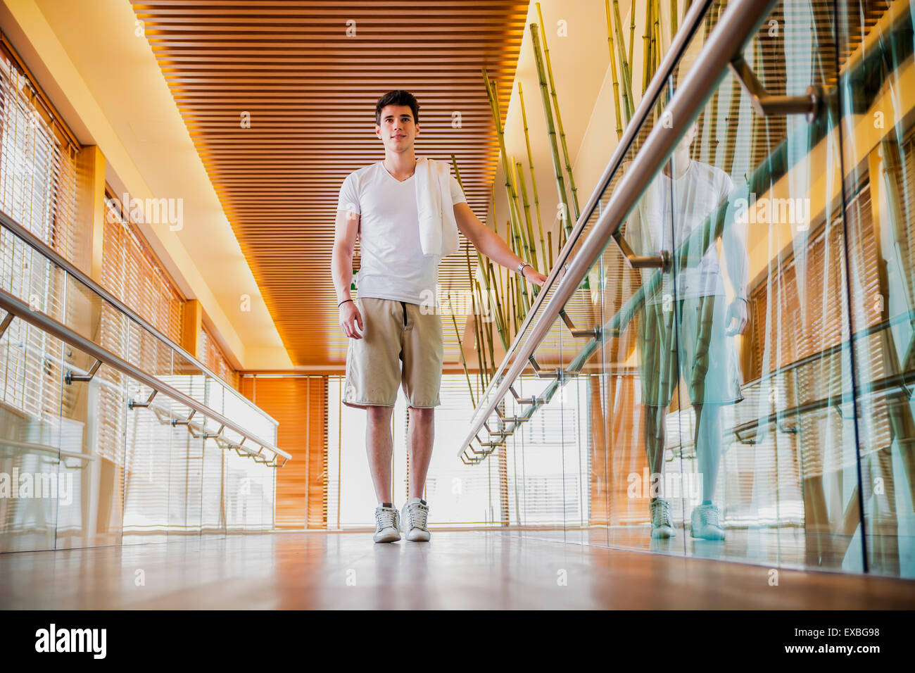 Low Angle View Full Length of Young Man with Towel Over Shoulder