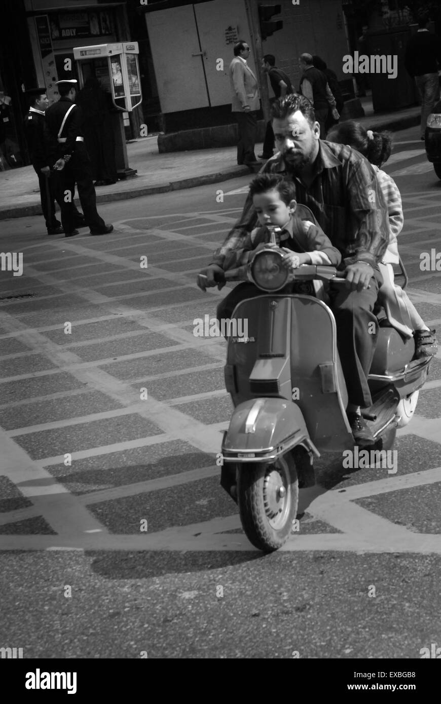 Father and two children on scooter, Cairo, Egypt Stock Photo