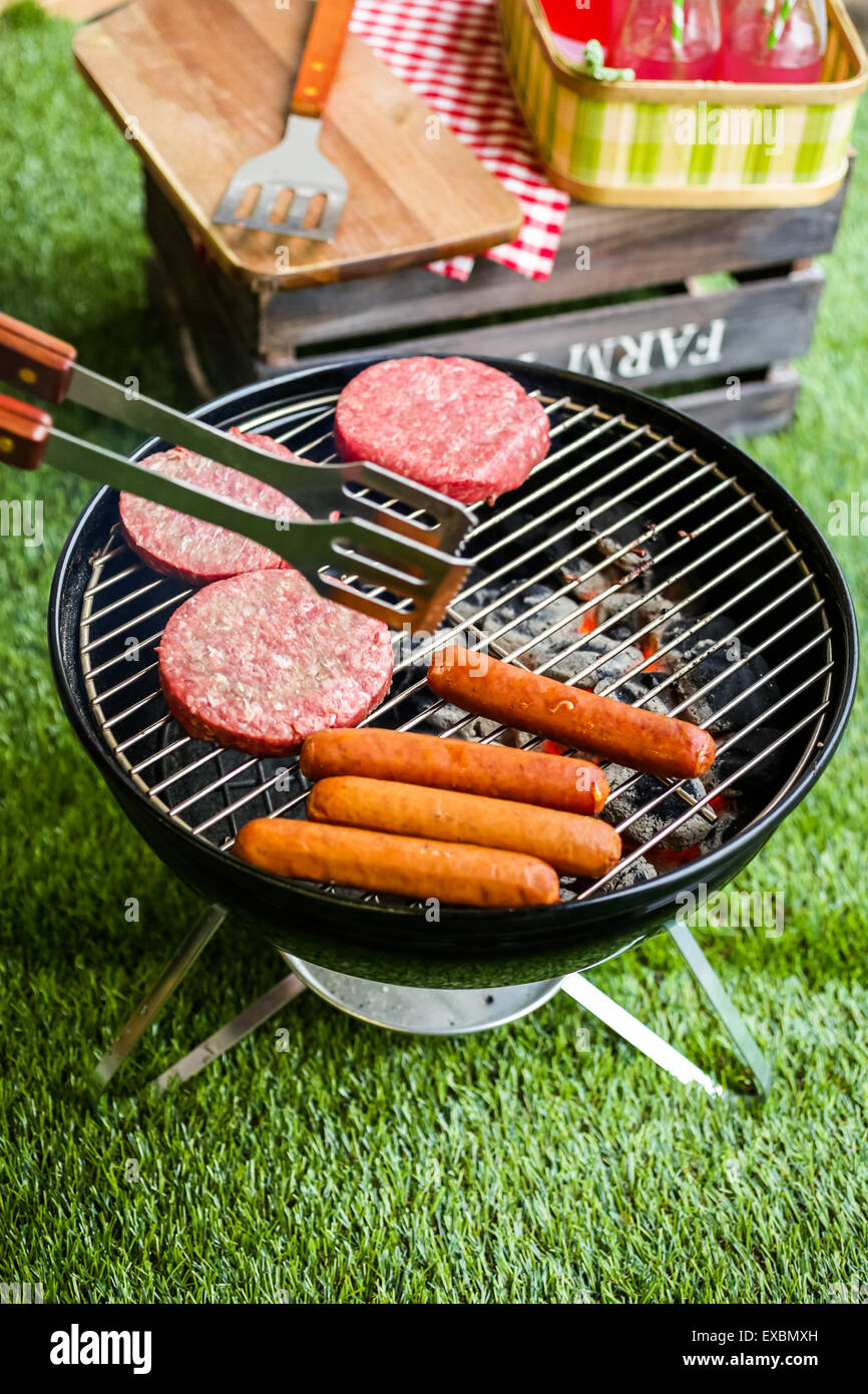 Summer picnic with small charcoal grill in the park Stock Photo Alamy