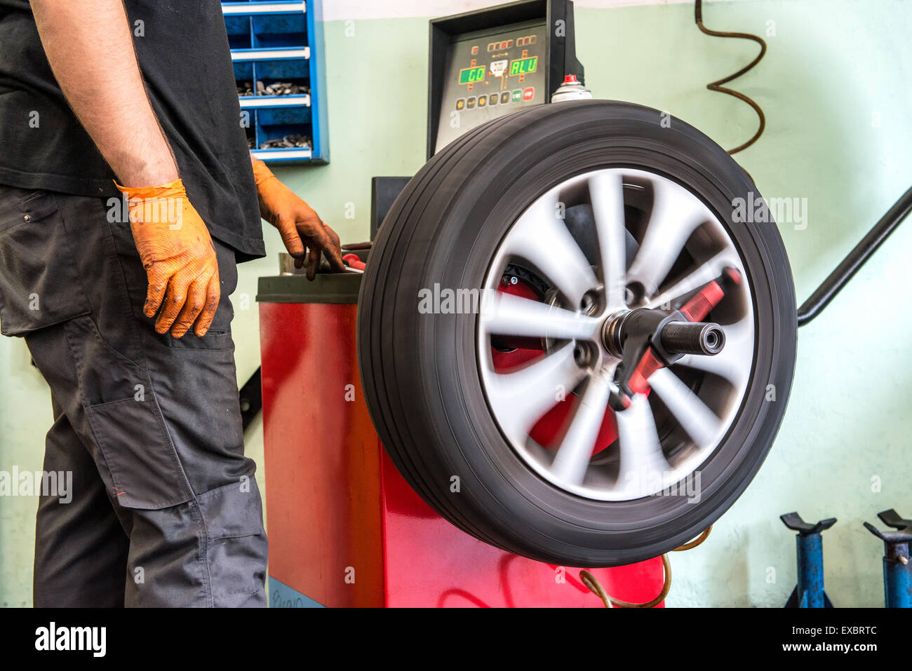 Mechanic balancing a car wheel Stock Photo Alamy