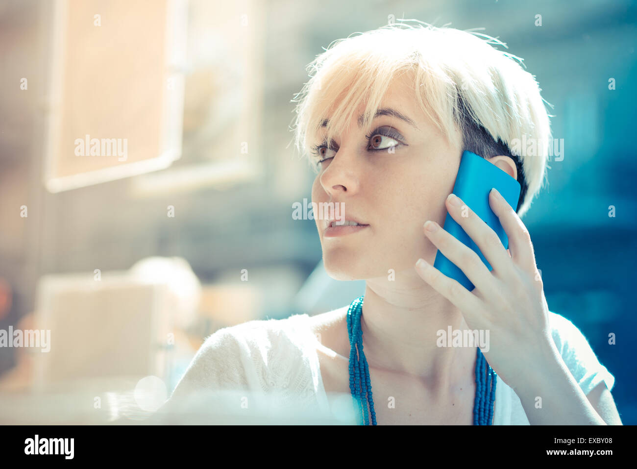 Beautiful Young Blonde Short Hair Hipster Woman Using Smart Phone