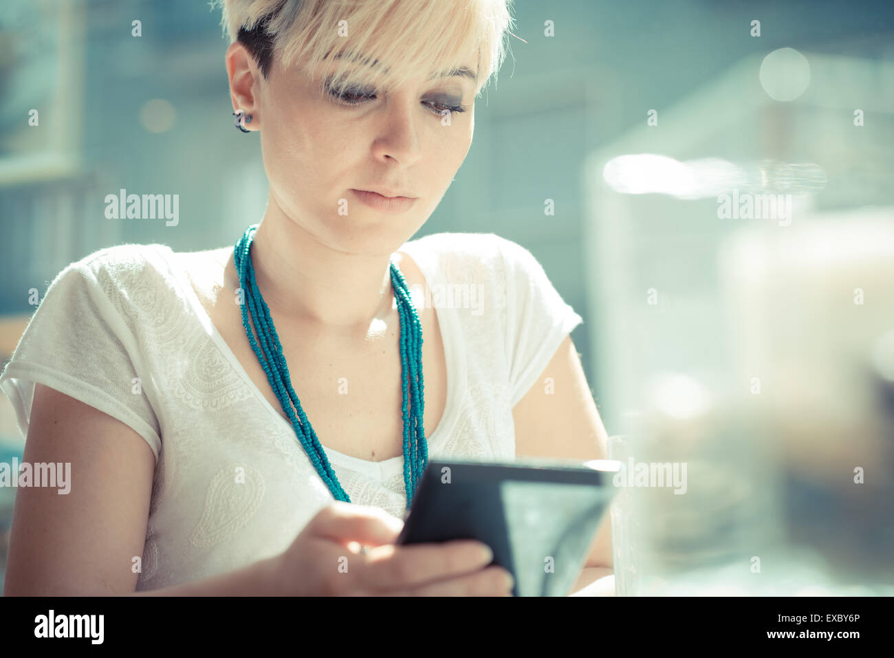 Beautiful Young Blonde Short Hair Hipster Woman Using Tablet At