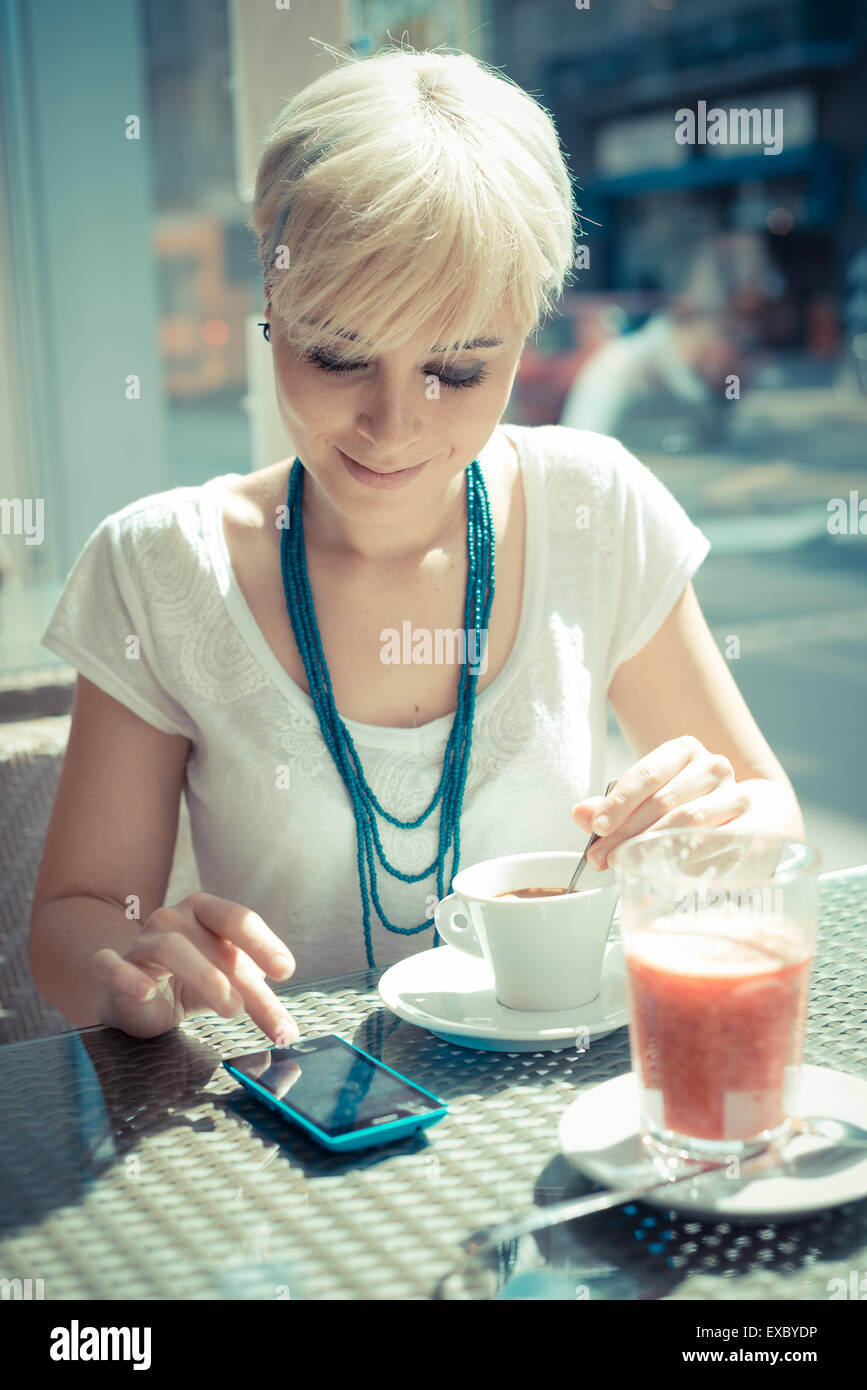 Beautiful Young Blonde Short Hair Hipster Woman Using Smart Phone