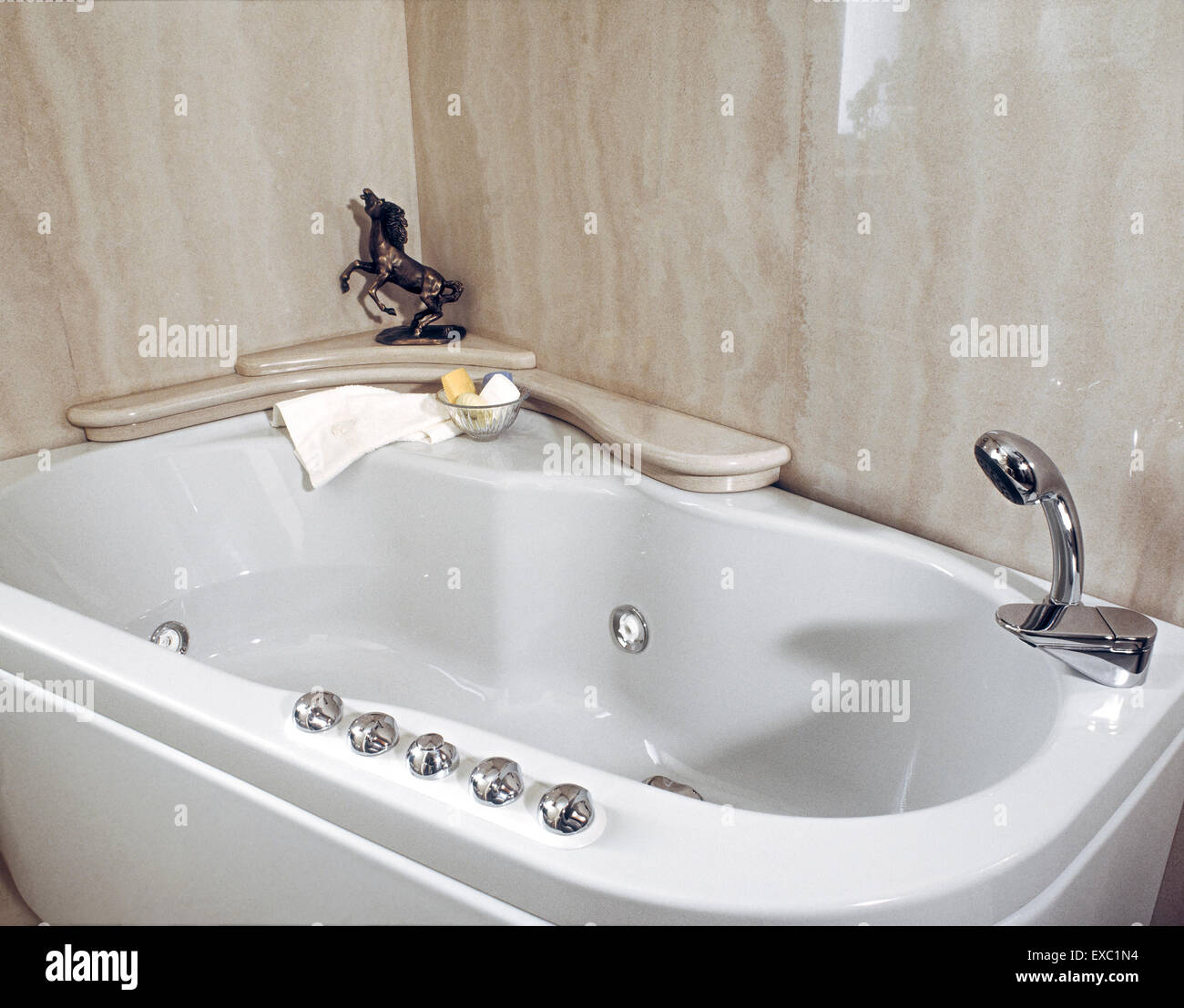 foreground of bathtub in the classic bathroom whose walls are coated with marble Stock Photo