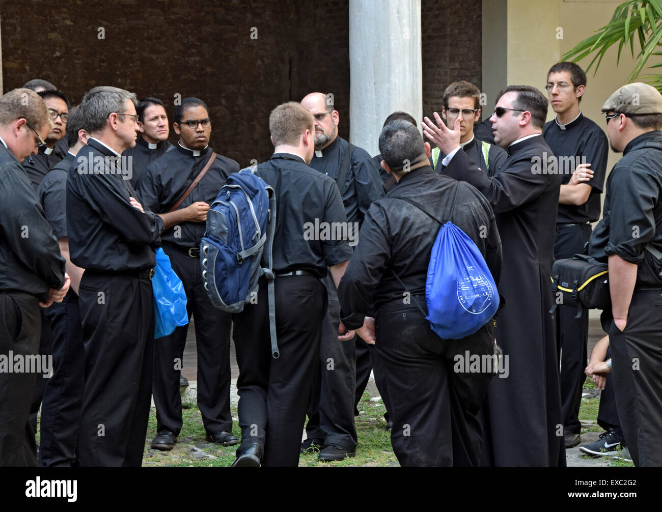 A group of priests on a tour of the Basilica of San Clemente in Rome, Italy. Stock Photo