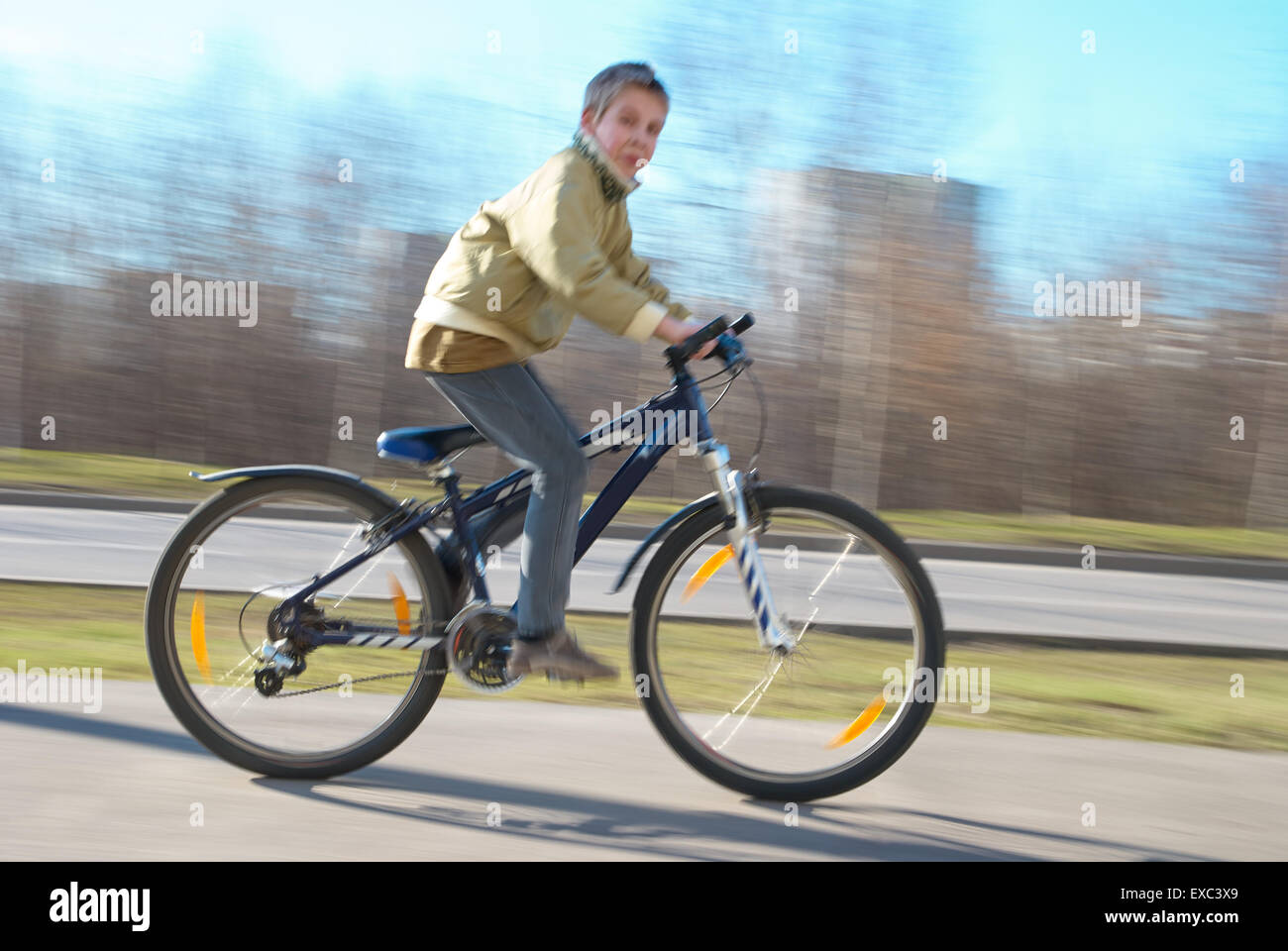 Someone Riding Fast Boy rides very fast on the walkway. The image is blurry because of very ...
