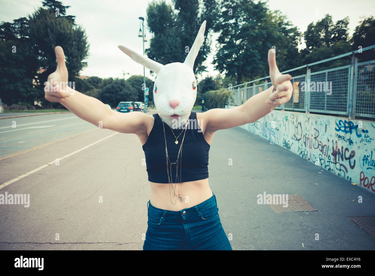 rabbit mask woman abusrd unreal in the city Stock Photo