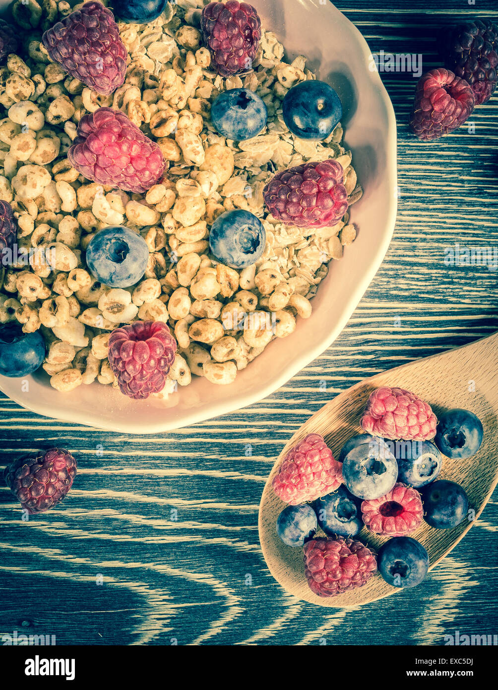 Cereal and fresh fruits arranged on a wooden table Stock Photo