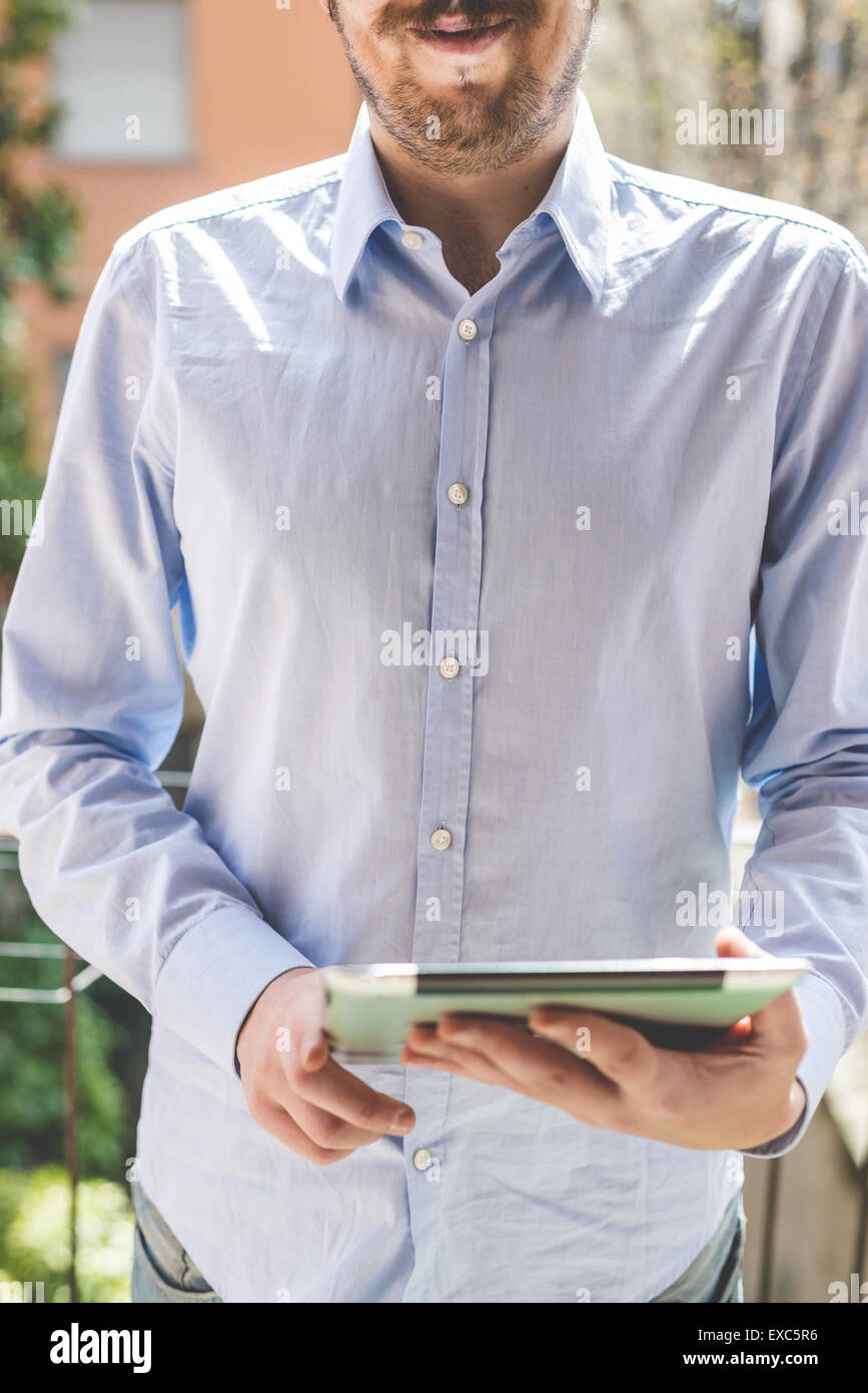 elegant business multitasking multimedia man using devices at home