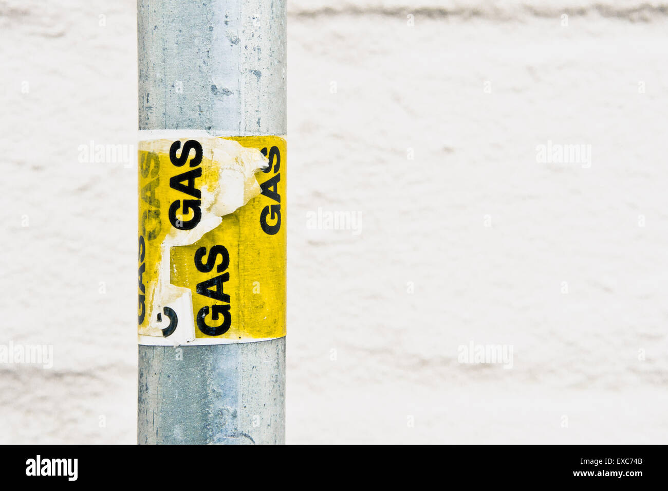 Yellow gas labels on a metal post Stock Photo