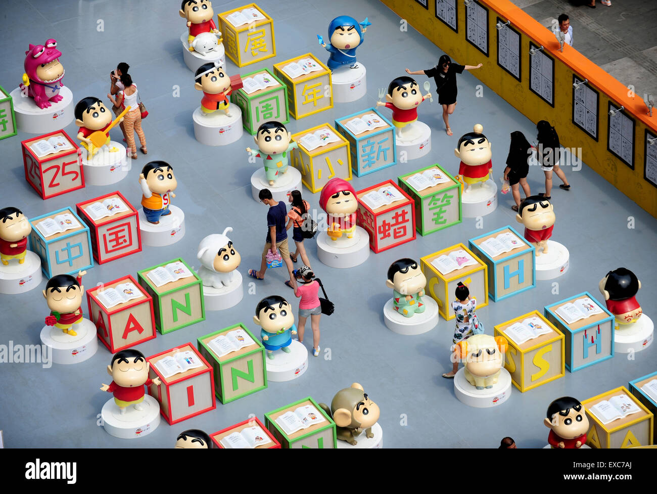 Shenyang. 11th July, 2015. Citizens visit an exhibition marking the 25th anniversary of Japanese manga series Crayon Shin-chan in Shenyang, northeast China's Liaoning Province July 11, 2015. Dozens of manga and theatrical version of Crayon Shin-chan and related figures were displayed on the exhibition that opened to public on Saturday. © Xinhua/Alamy Live News Stock Photo