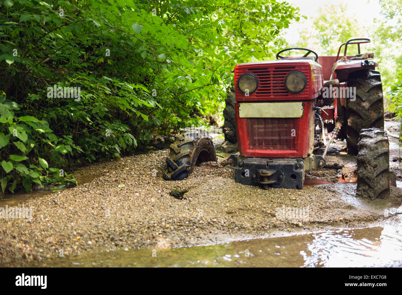 Tractor stuck in the mud on a river Stock Photo Alamy