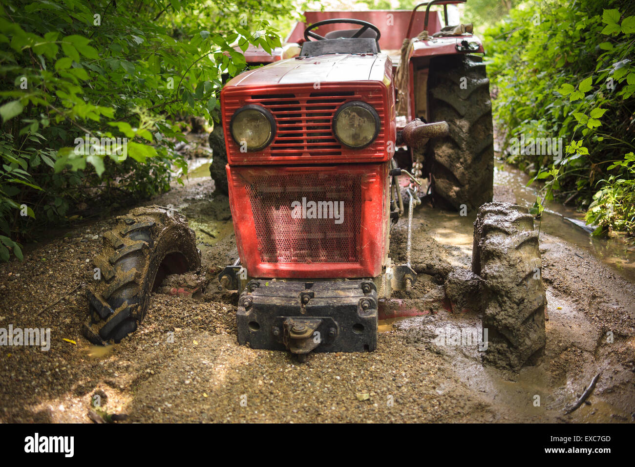 Tractor stuck in the mud on a river Stock Photo Alamy