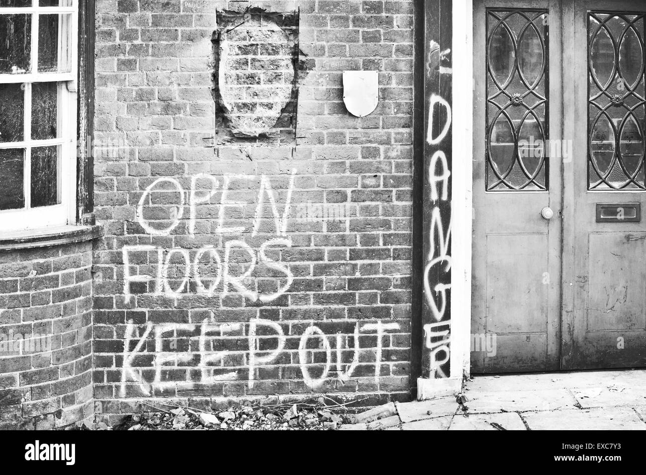 Parr of a building before demolition with warning graffiti Stock Photo