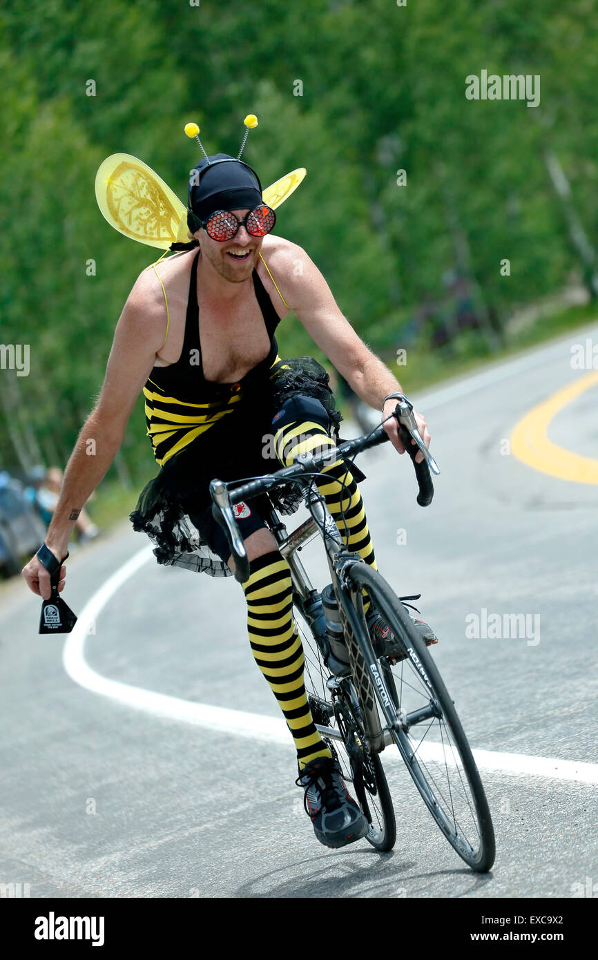 Man dressed as a bee riding a bicycle, USA Pro Challenge bicycle race, McClure Pass, Colorado USA Stock Photo