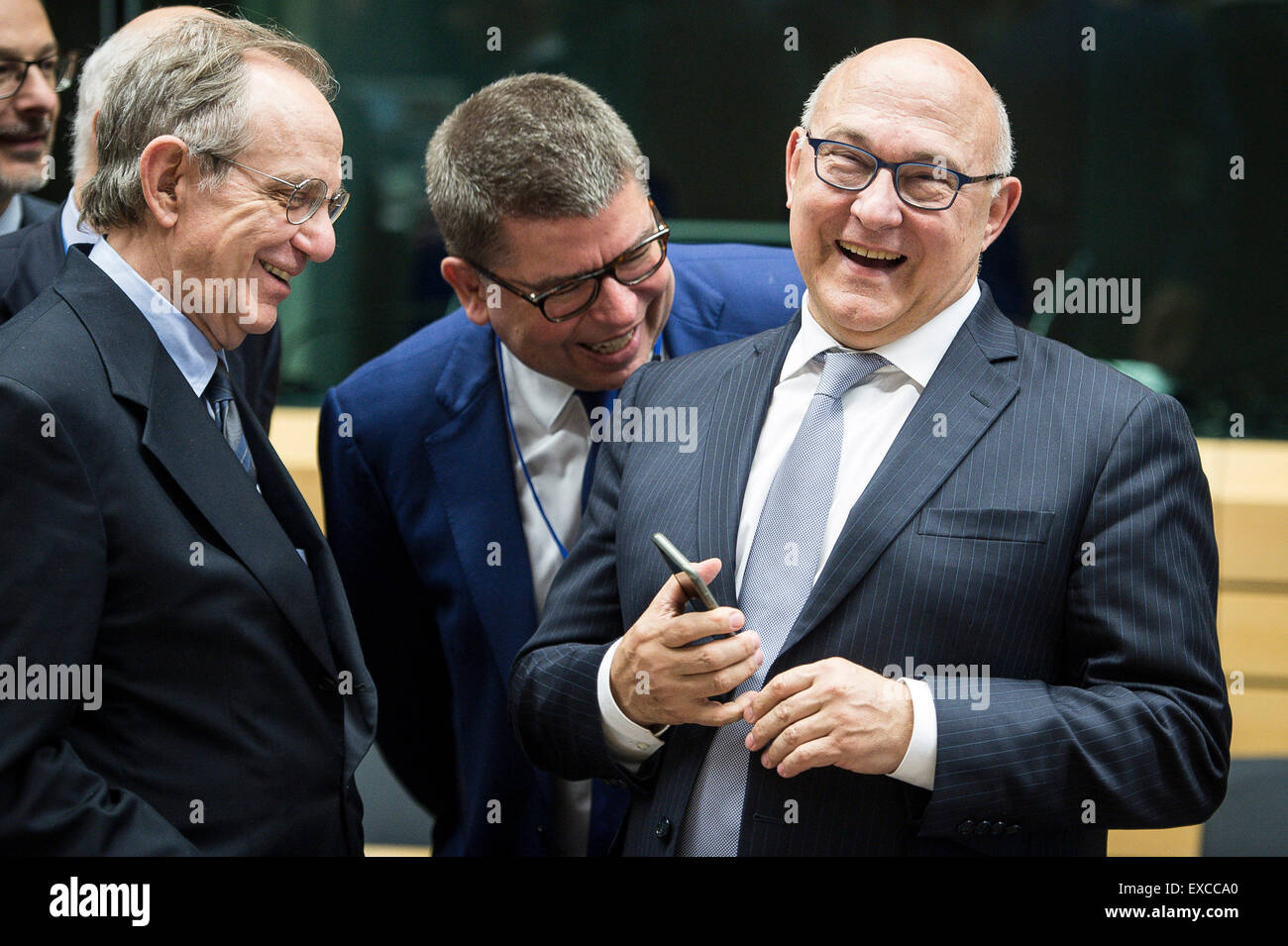 Brussels, Bxl, Belgium. 11th July, 2015. (L-R) Pier Carlo Padoan, Italian Minister for Economy and Finances and French Foreign Minister Michel Sapin prior to the Eurogroup, finance ministers of the single currency EURO zone meeting at EU headquarters in Brussels, Belgium on 11.07.2015 Finance Ministers meet to evaluate Greece's request for a new bailout package by Wiktor Dabkowski Credit:  Wiktor Dabkowski/ZUMA Wire/Alamy Live News Stock Photo