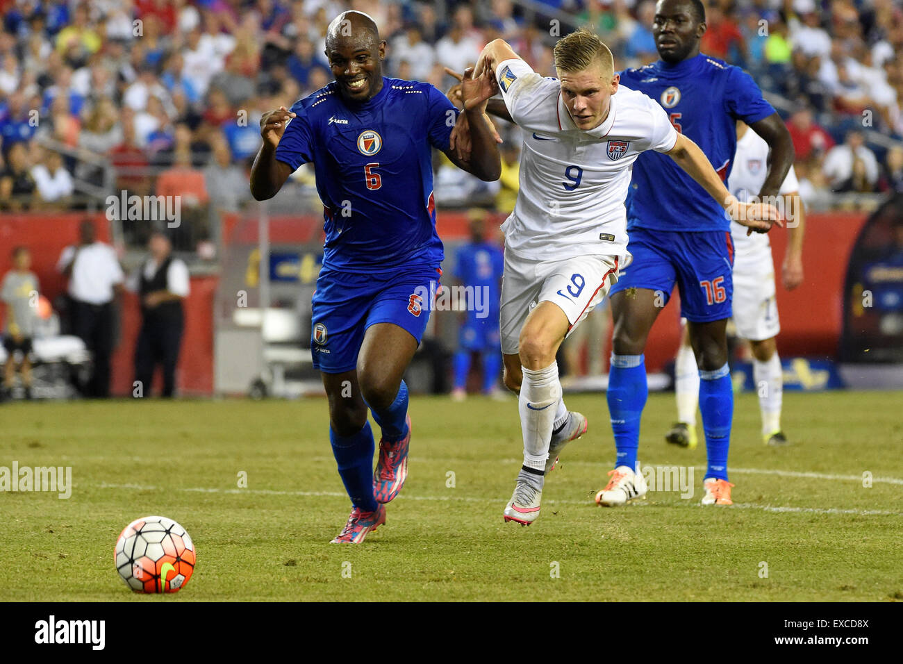 Foxborough, Massachusetts, USA. 10th July, 2015. United States forward Aron Johannsson (9) and Haiti defender Frantz Bertin (6) battle their way to the ball during the CONCACAF Gold Cup group stage match between USA and Haiti held at Gillette Stadium, in Foxborough Massachusetts. USA defeated Haiti 1-0. Eric Canha/CSM/Alamy Live News Stock Photo