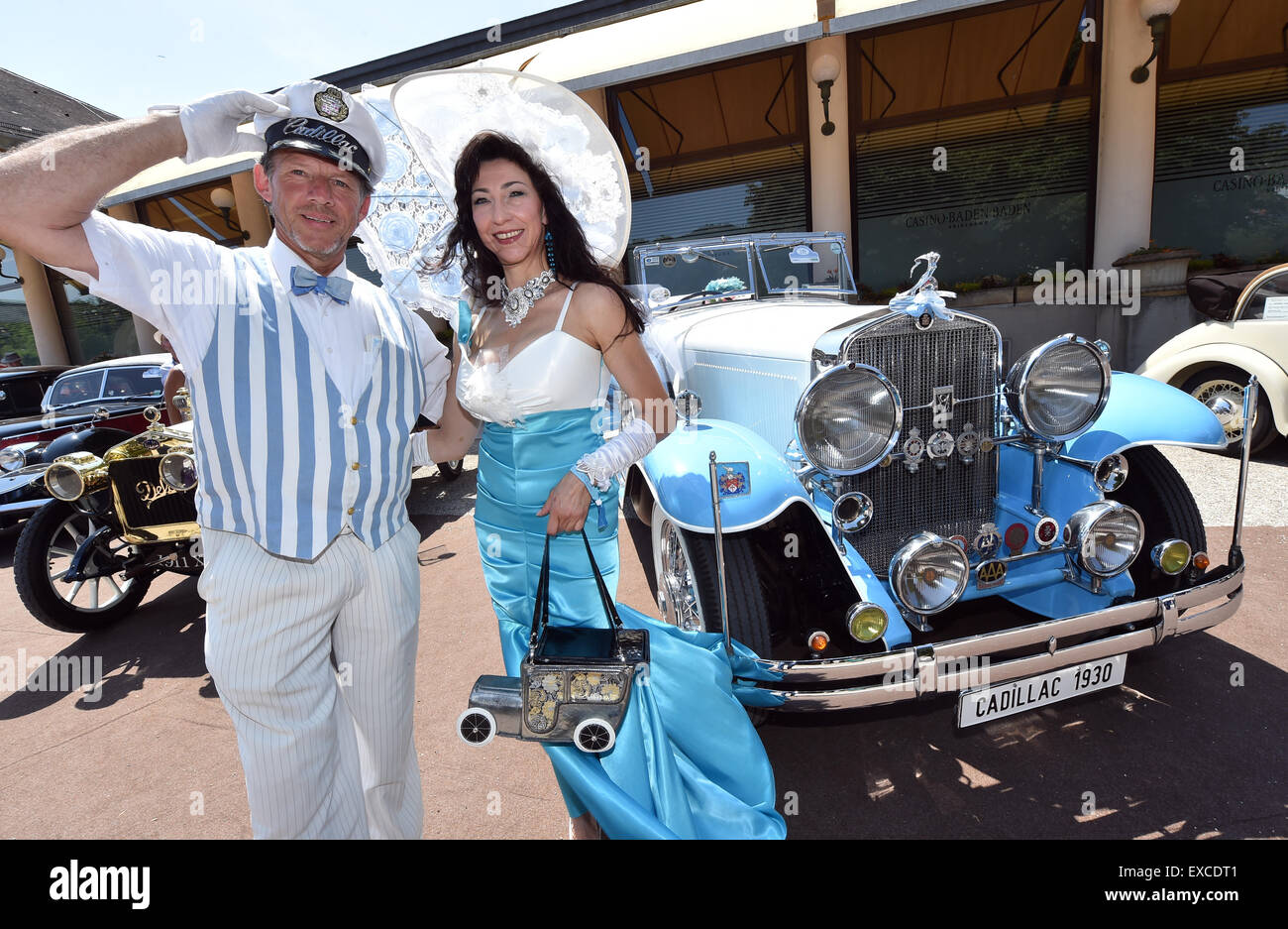 Baden-Baden, Germany. 11th July, 2015. Andreas Wietzke and Esther Bernd stand in front of a 1930 Cadillac Imperial at the 39th vintage car show 'International Oldtimer-Meeting' in Baden-Baden, Germany, 11 July 2015. 400 classic cars will be showcased during the exhibition held from 10 to 12 July. PHOTO: ULI DECK/dpa/Alamy Live News Stock Photo