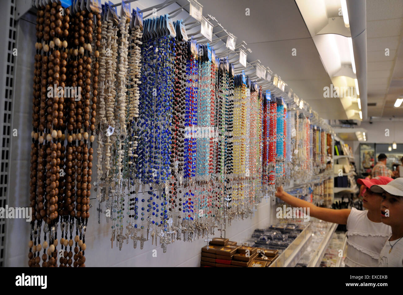 Children looking at rosaries in shop wth devotional articles in Mostar. Stock Photo