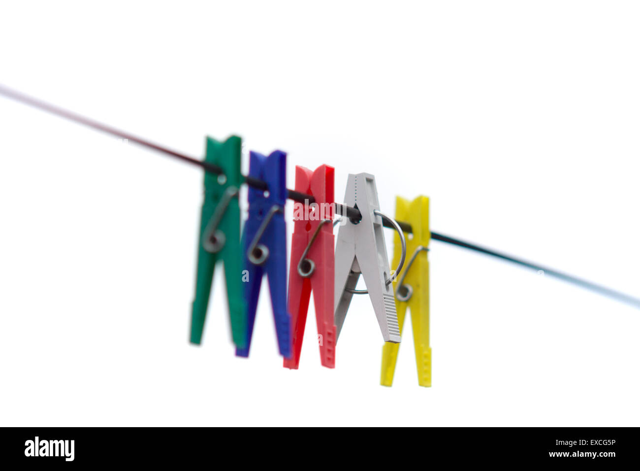 clothes pegs of different flowers hang on the tense rope for linen drying Stock Photo