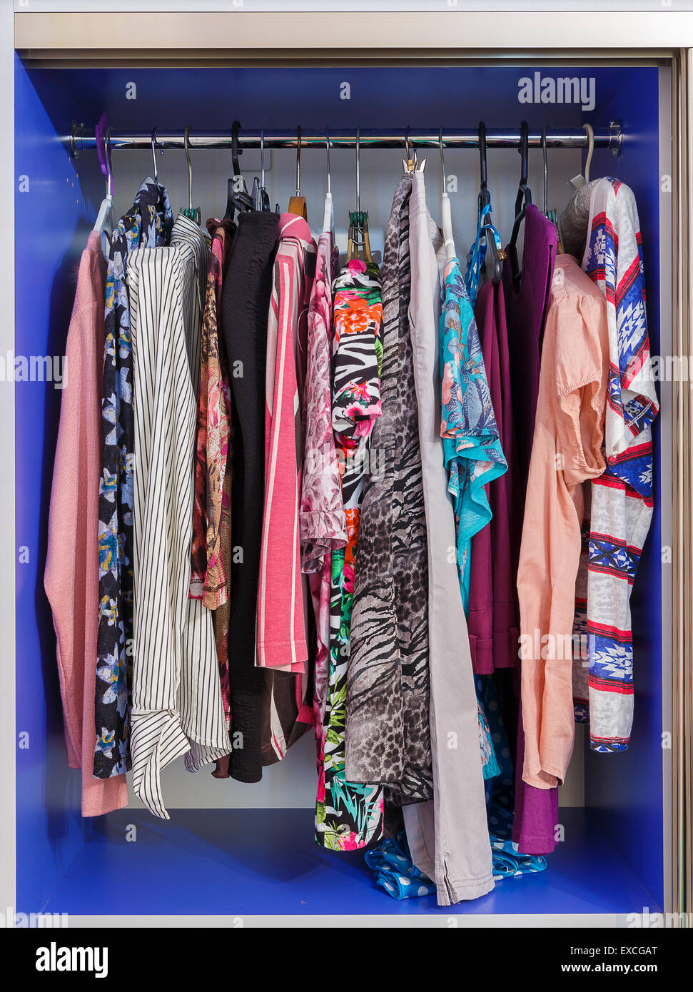 Wardrobe with hanging clothes on hangers Stock Photo
