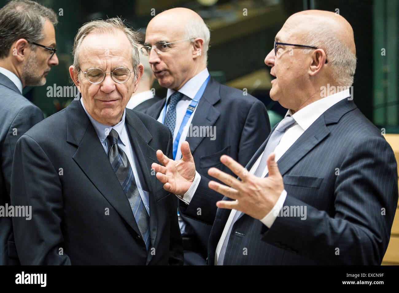 (L-R) Pier Carlo Padoan, Italian Minister for Economy and Finances and French Foreign Minister Michel Sapin prior to the Eurogroup , finance ministers of  the single currency EURO zone  meeting at EU headquarters in Brussels, Belgium on 11.07.2015 Finance Ministers meet to evaluate Greece's request for a new bailout package by Wiktor Dabkowski Stock Photo