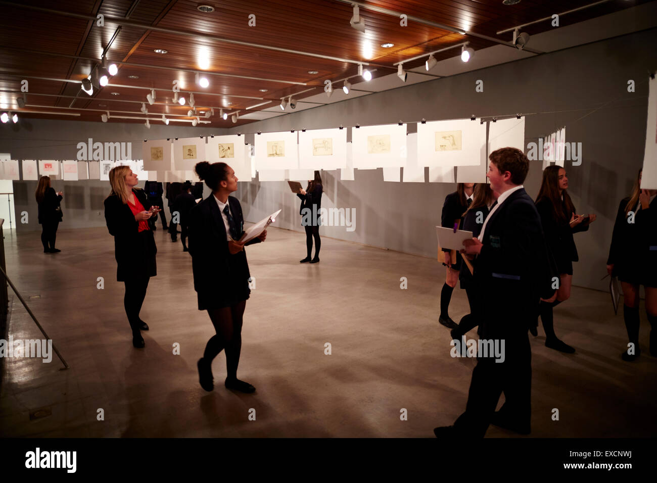 School children looking at displays of managing artwork at Whitworth Art gallery     containing about 55,000 items in its collec Stock Photo