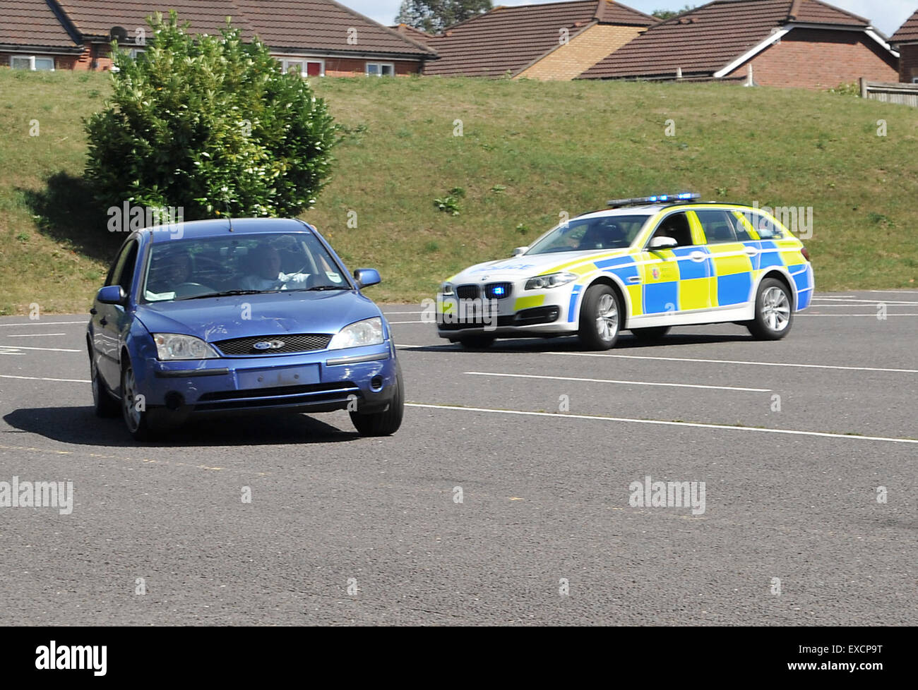 Maidstone, Kent, UK. 11th July, 2015. Police officers demostrate their skills and equipment at the Kent Police Open Day. Traffic officers chase a fleeing suspect. Credit:  Matthew Richardson/Alamy Live News Stock Photo