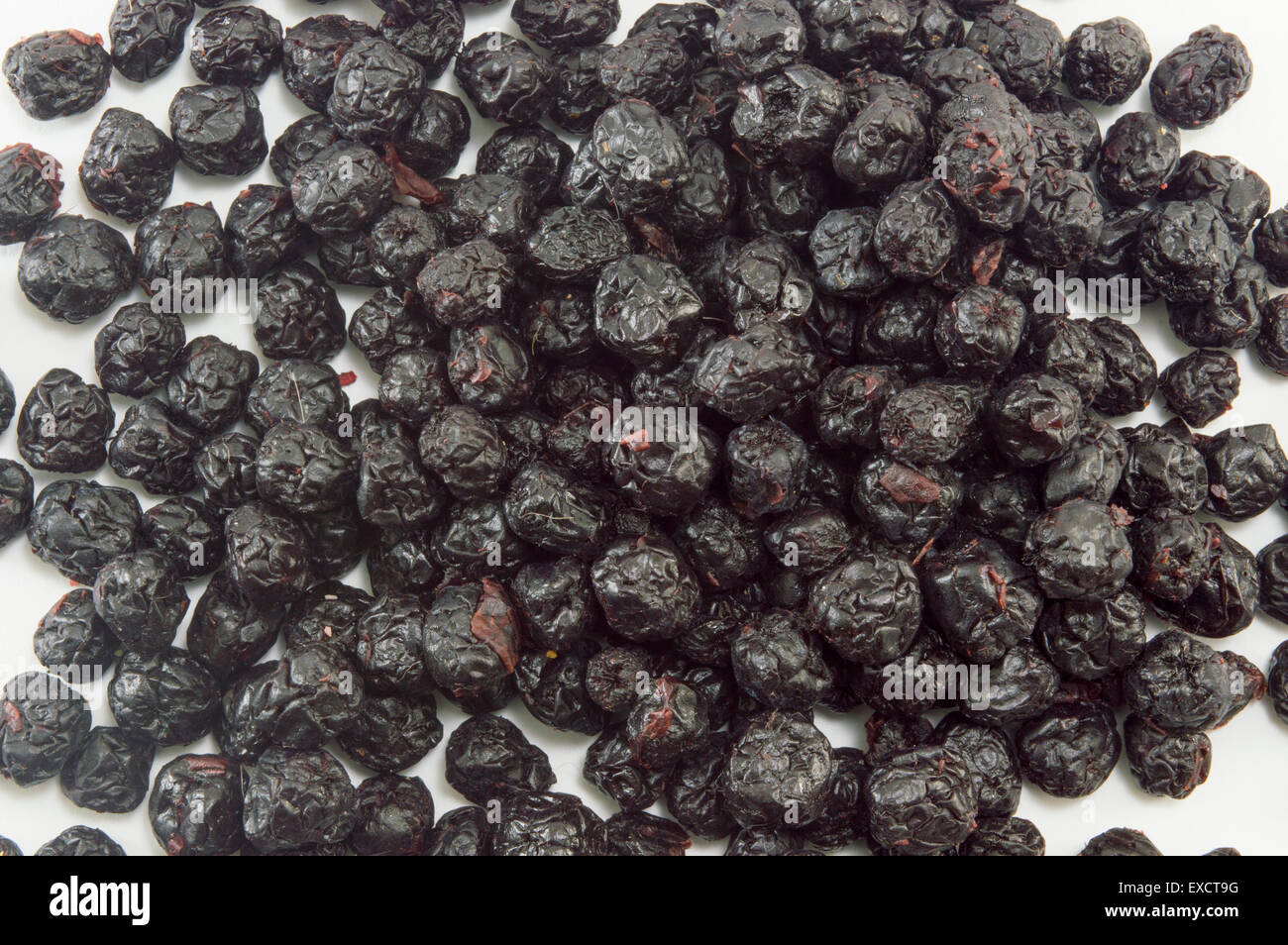 Bunch of dried aronia berries forming background Stock Photo