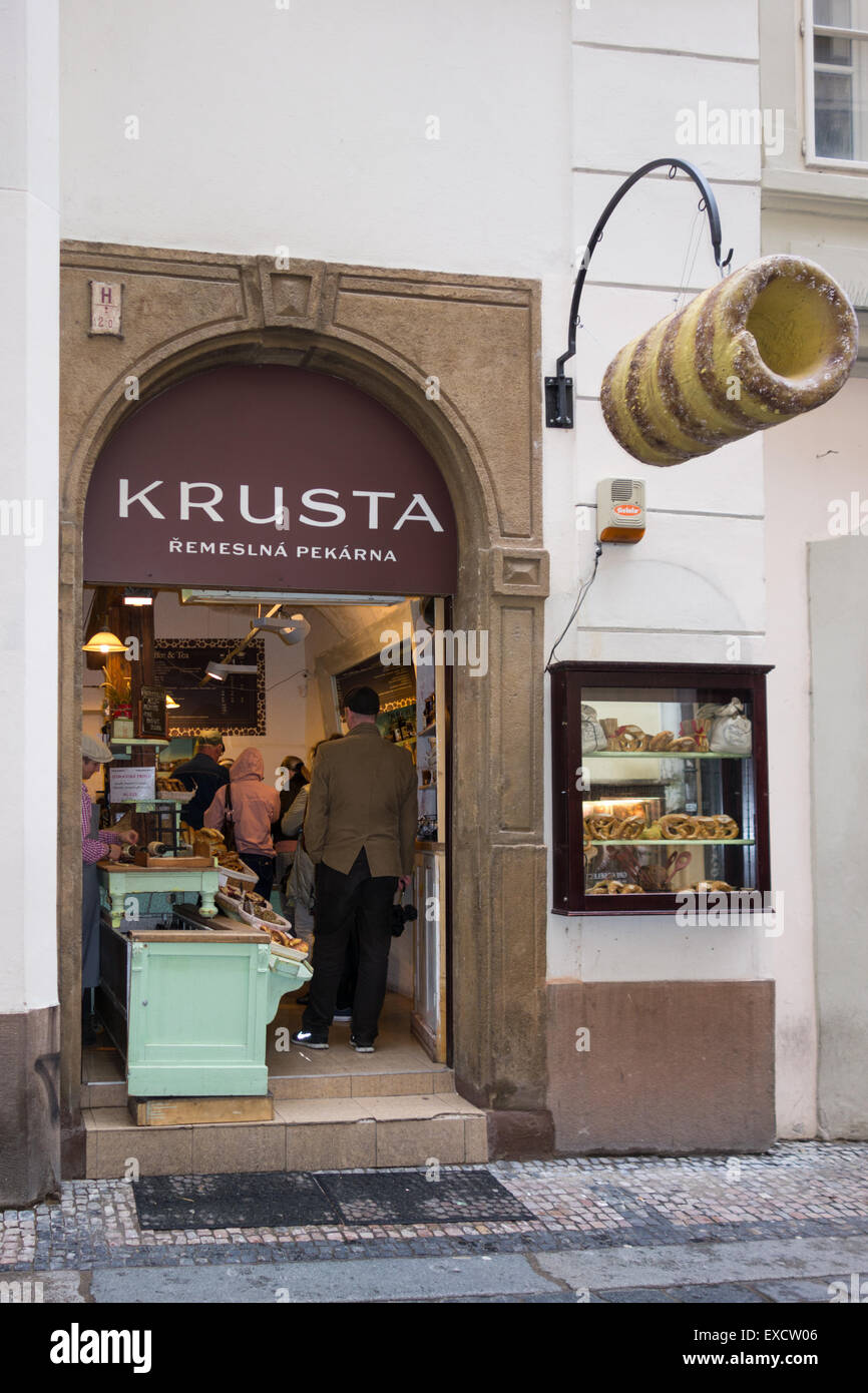 customers queuing for Trdelnik - a traditional Slovak cake and sweet pastry - at Krusta Artisan Bakery shop in Prague Old Town, Stock Photo