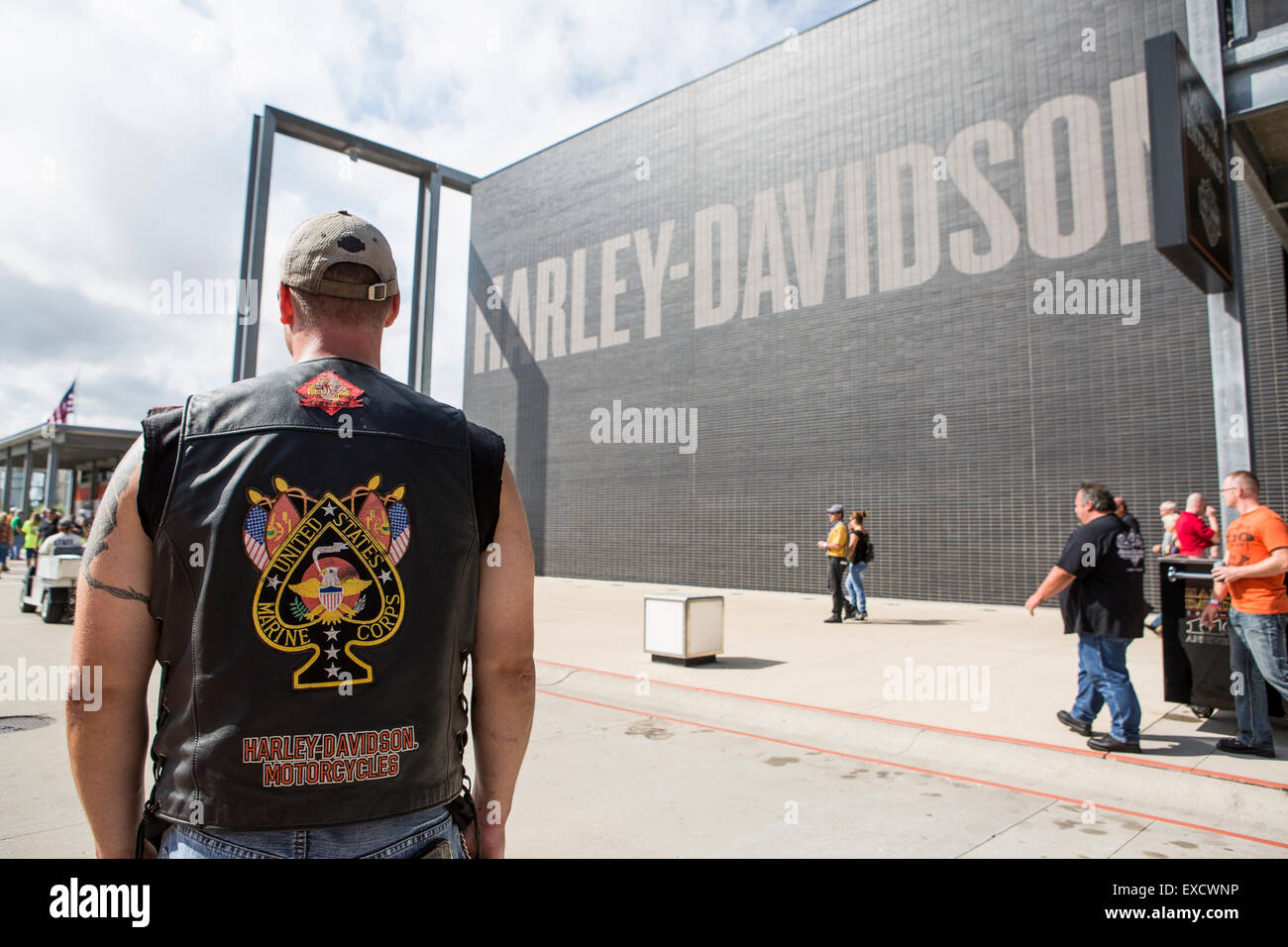 A man with a custom Marine Corps Harley-Davidson vest stands outside of the Harley-Davidson Museum in Milwaukee, Wisconsin. Stock Photo