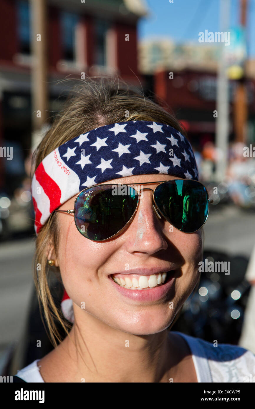 A Harley-Davidson motorcycle rider shows off a patriotic headband during a Harley motorcycle rally. Stock Photo