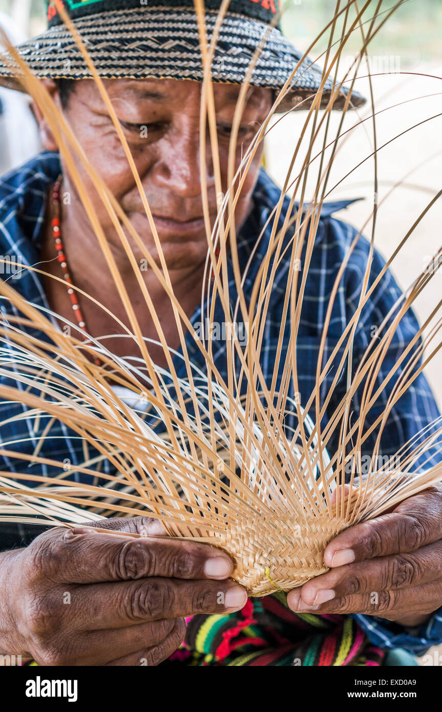 Wayuu indigenous man constructing a bamboo hat in the regional style of La Guajira, Colombia.  Weaving is mostly a female profes Stock Photo