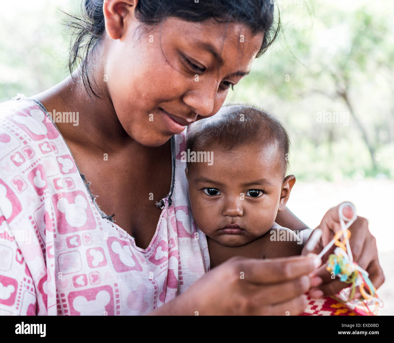 Young Wayuu indigenous woman and her baby in a 'rancheria', or traditional rural settlement, in La Guajira, Colombia. Stock Photo