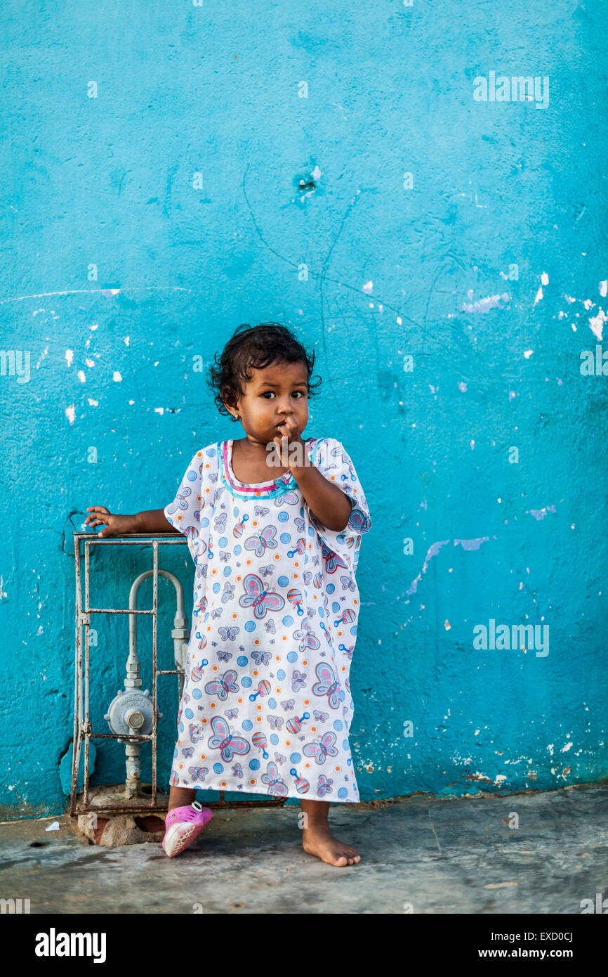 A young 2-5 year old Wayuu indigenous girl outside her home in a low-income neighborhood of Uribia, La Guajira, Colombia. Stock Photo