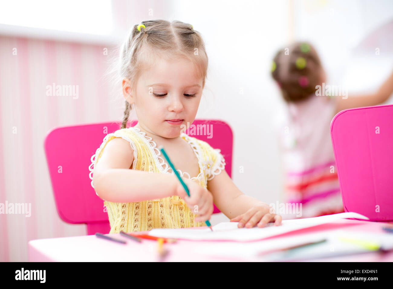 kids girls painting in nursery at home Stock Photo