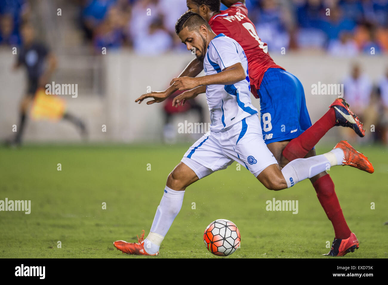 Houston, Texas, USA. 11th July, 2015. El Salvador forward Irvin Herrera (19) takes a shot while being defended by Costa Rica defender Dave Myrie (8) during the 2nd half of an international CONCACAF Gold Cup soccer match between Costa Rica and El Salvador at BBVA Compass Stadium in Houston, TX. The game ended in a 1-1 draw. Credit:  Cal Sport Media/Alamy Live News Stock Photo