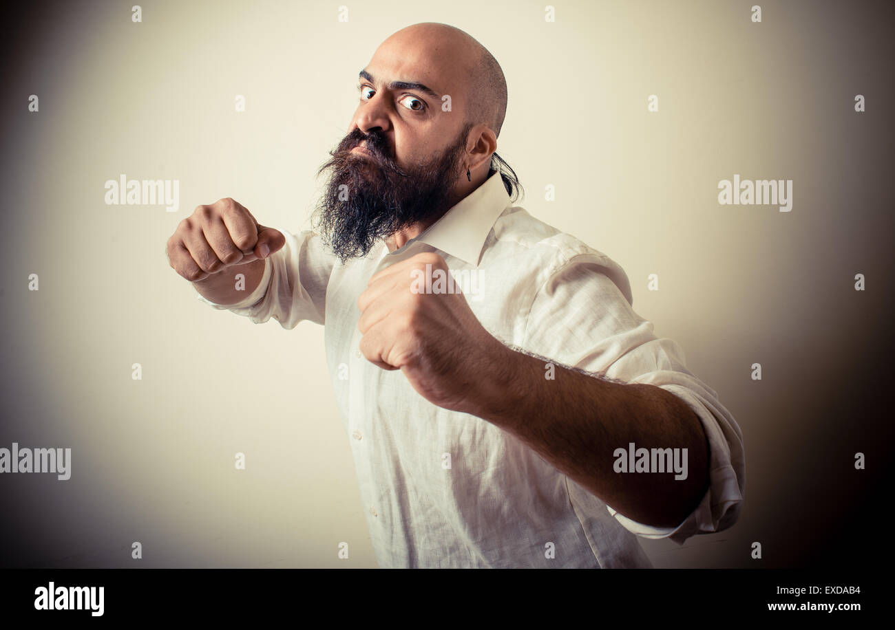 angry fighter long beard and mustache man  on gray background Stock Photo