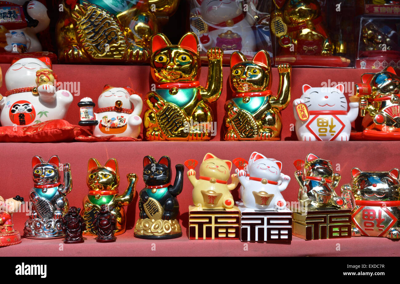 Beckoning or Lucky Cats in a shop window Stock Photo
