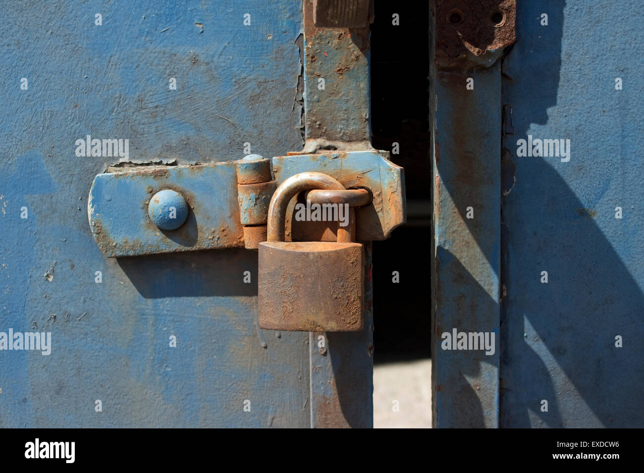 old door with blue chipped paint and rusted padlock Stock Photo Alamy