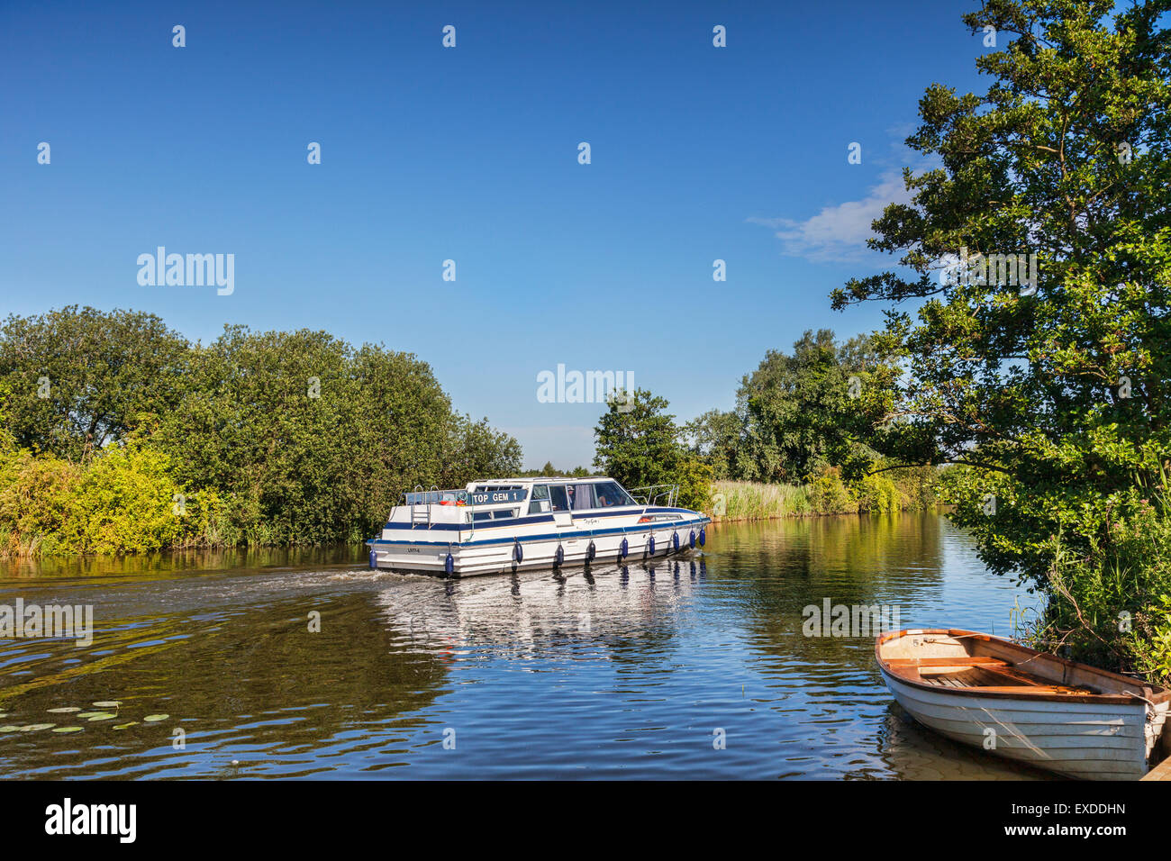 Motor cruiser on the Norfolk Broads near How Hill, Norfolk, England Stock Photo