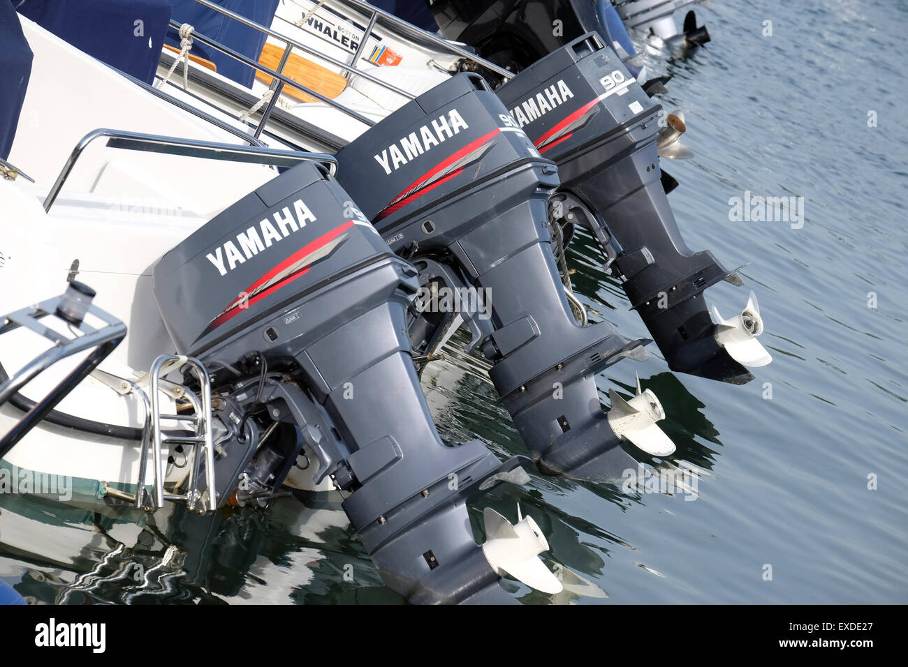 Yamaha motor Boat engines in a row at Salcombe in Devon Stock Photo