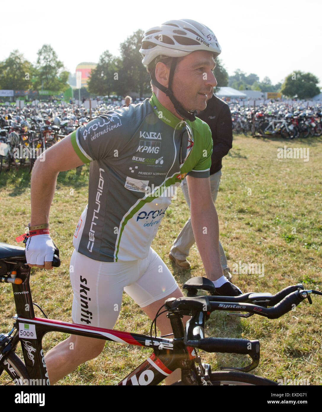 Hilpoltstein, Germany. 12th July, 2015. Heiko Maas (SPD), German Minister of Justice, before the cycling stage at the Datev Challenge Roth in Hilpoltstein, Germany, 12 July 2015. According to the organizers of the triathlon, the minister participated in the cycling stage just for fun. The participants of the 14th edition of the Datev Challenge Roth triathlon have to complete the ironman distance of 3, 8 km swimming, 180 km cycling and a marathon. Photo. DANIEL KARMANN/dpa/Alamy Live News Stock Photo