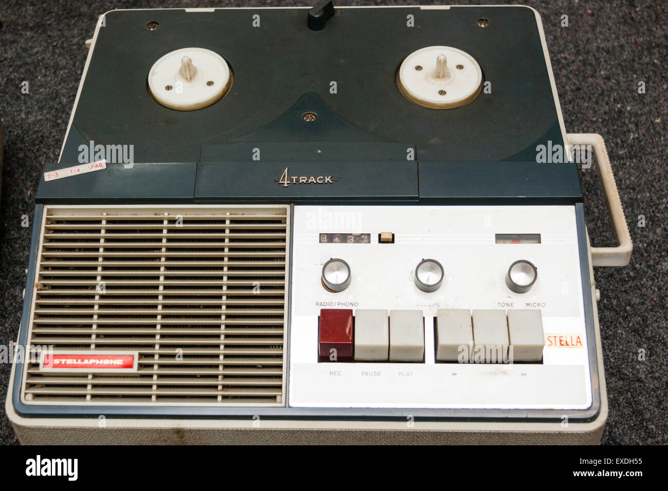 Stellaphone 4 track reel to reel tape recorder against dark background