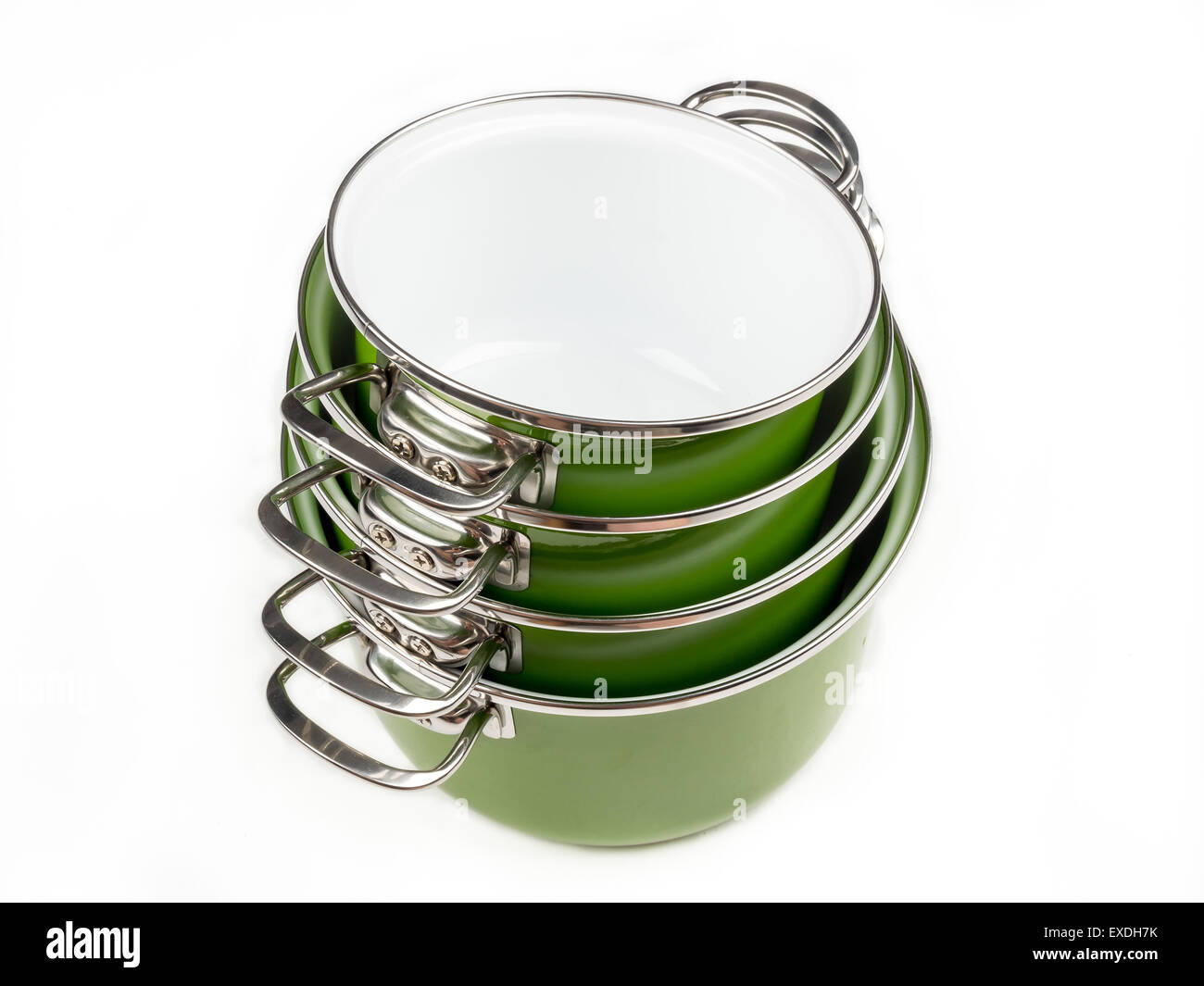 Set of four stacked green enamel pots shot from above on white background Stock Photo