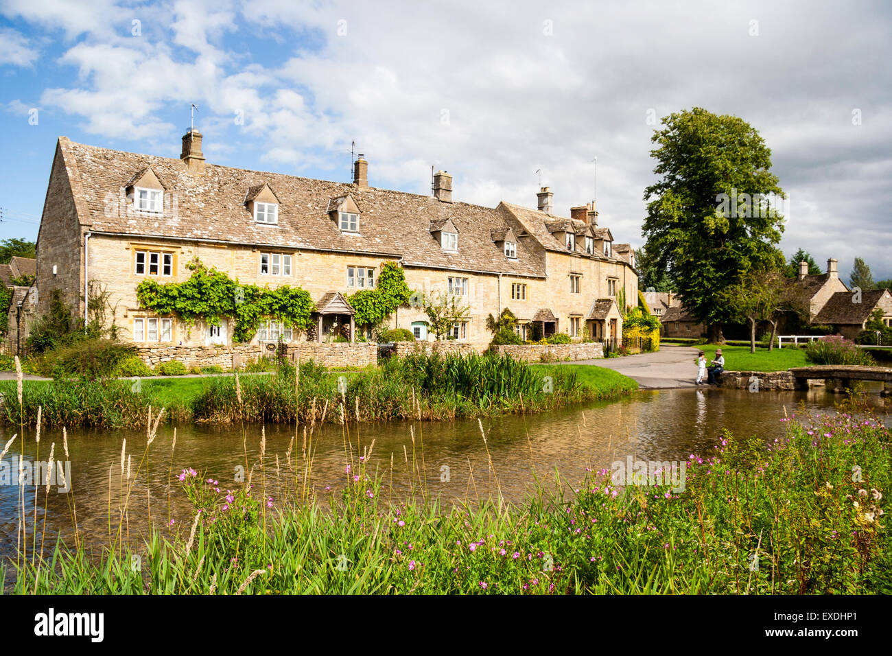 Picture postcard view of row of Cotswold stone cottage terrace houses