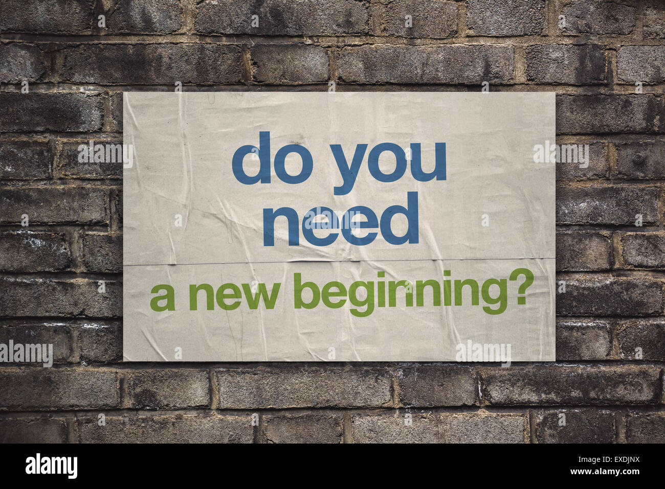 Do You Need a New Beginning on Rustic Poster Paper Glued to Old Brick Wall, Retro Toned Vintage Effect Stock Photo